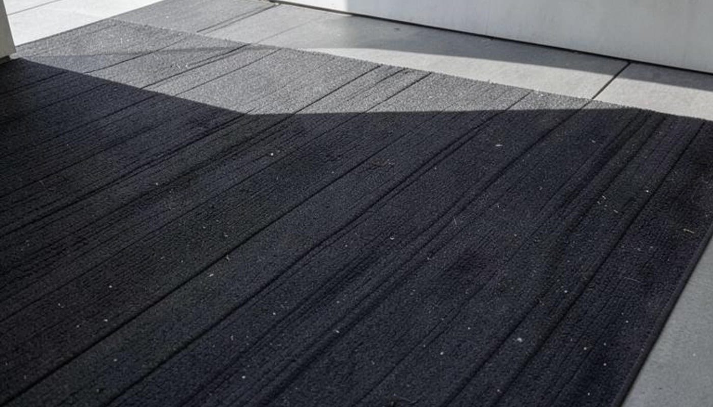 Close-up photograph of dark diagonal textures in a minimalist setting
