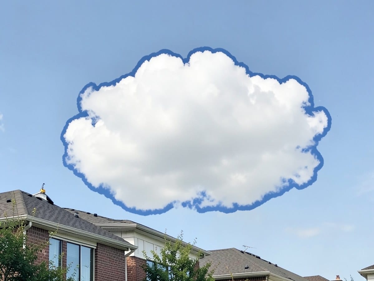 single, fluffy white cloud floats in a light blue sky, with a darker blue outline.