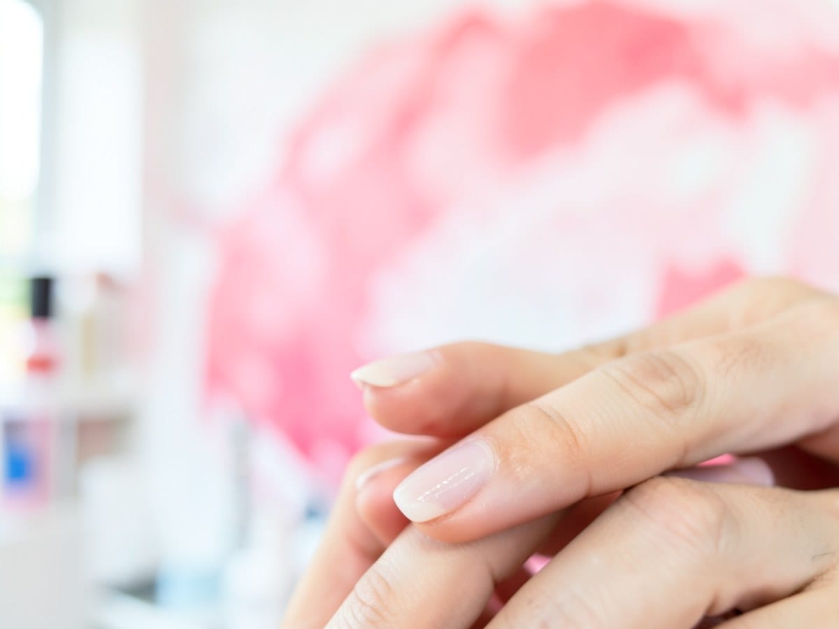 soft, blurred background of pink and white hues, resembling a painting or abstract design, creates a dreamlike quality.
